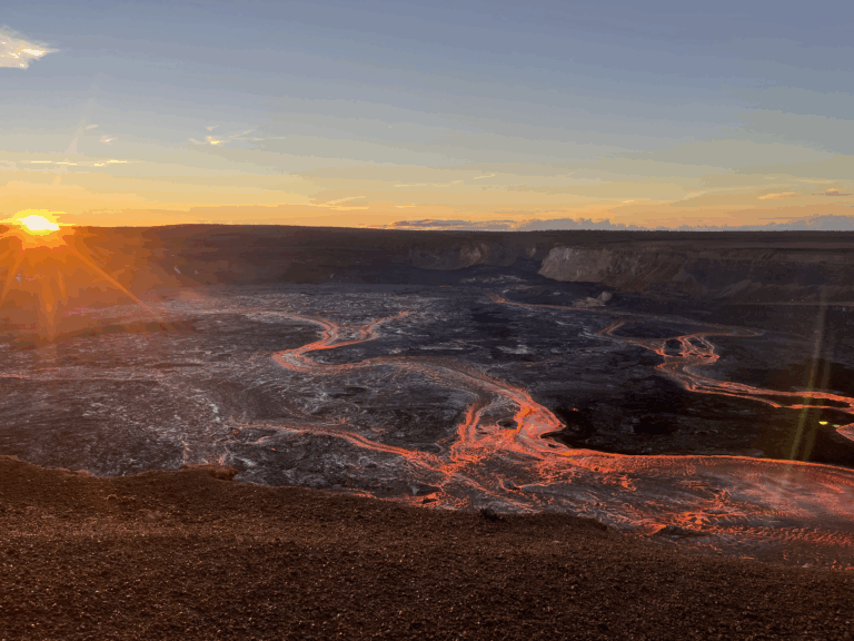 Sunrise over Kilauea's crater with flowing lava