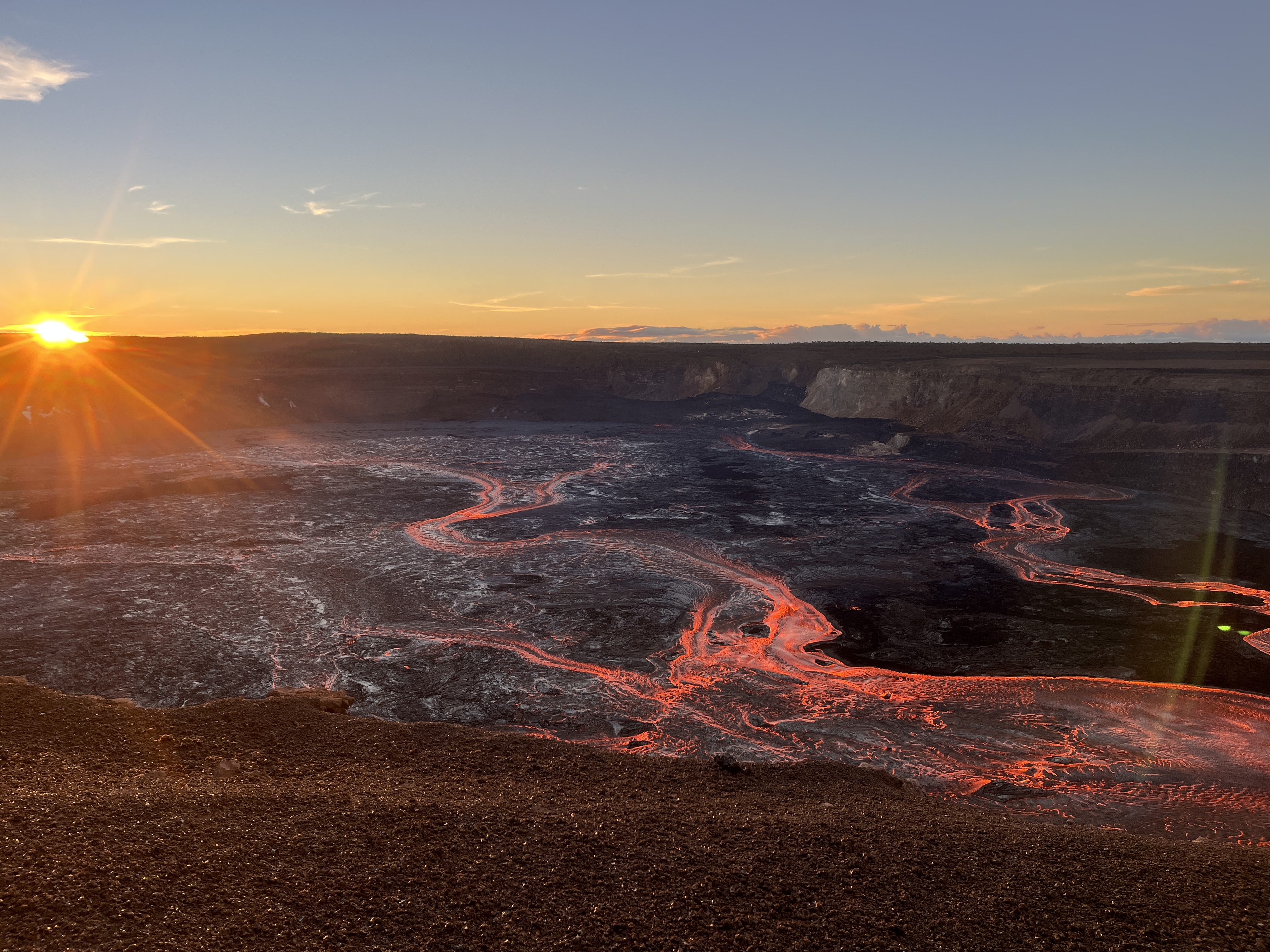 Sunrise over Kilauea's crater with flowing lava